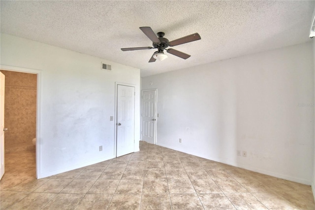 unfurnished bedroom with ceiling fan, visible vents, and a textured ceiling