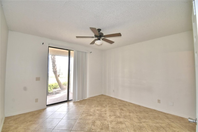 unfurnished room featuring a ceiling fan, light tile patterned flooring, a textured ceiling, and baseboards