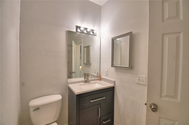 half bath with vanity and toilet