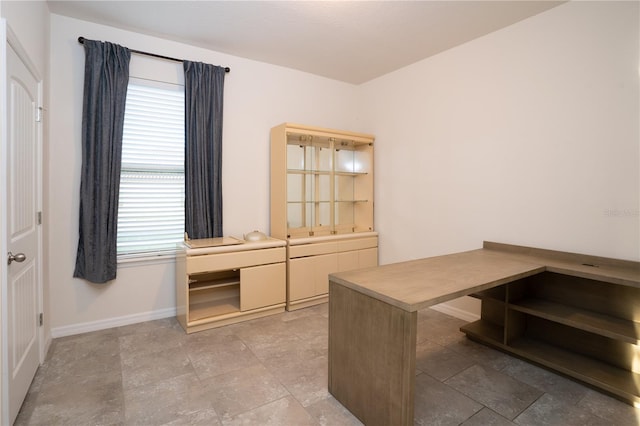 unfurnished office with baseboards