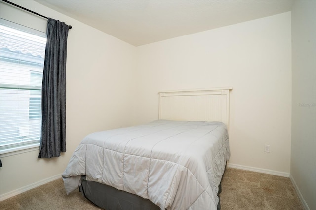 bedroom with carpet flooring and baseboards