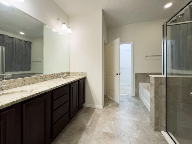 full bath with a garden tub, double vanity, a stall shower, and a sink