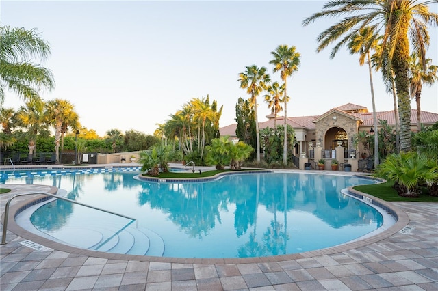 community pool with a patio area