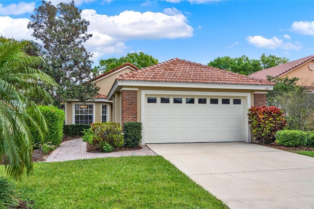 view of front of house featuring a tile roof, brick siding, stucco siding, an attached garage, and driveway