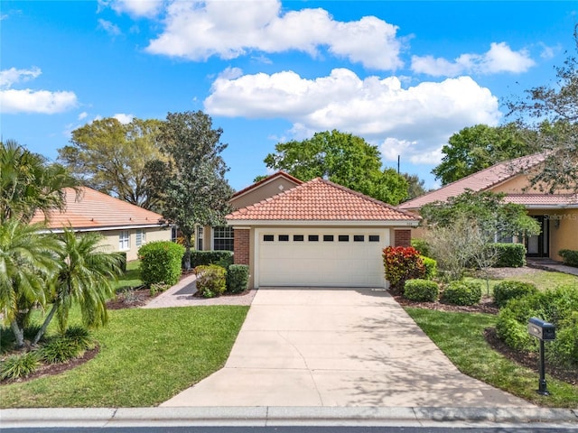 view of front of property with an attached garage, a tiled roof, concrete driveway, stucco siding, and a front lawn