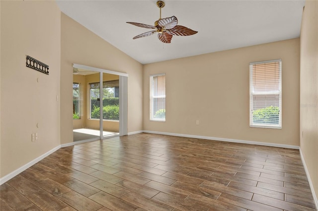 unfurnished room featuring lofted ceiling, ceiling fan, baseboards, and wood finished floors