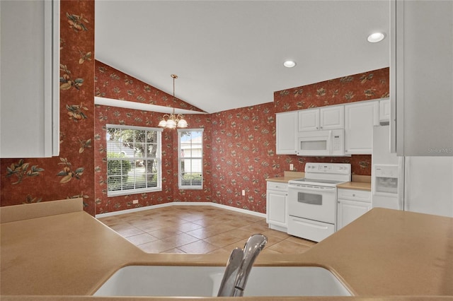 kitchen featuring white cabinetry, vaulted ceiling, a sink, white appliances, and wallpapered walls