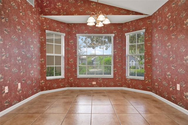 unfurnished dining area featuring vaulted ceiling, a chandelier, tile patterned flooring, baseboards, and wallpapered walls