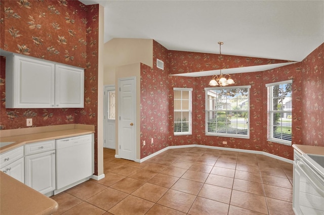 kitchen featuring vaulted ceiling, visible vents, dishwasher, and wallpapered walls