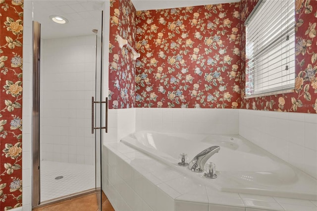 bathroom with wallpapered walls, a shower stall, tile patterned flooring, and a bath