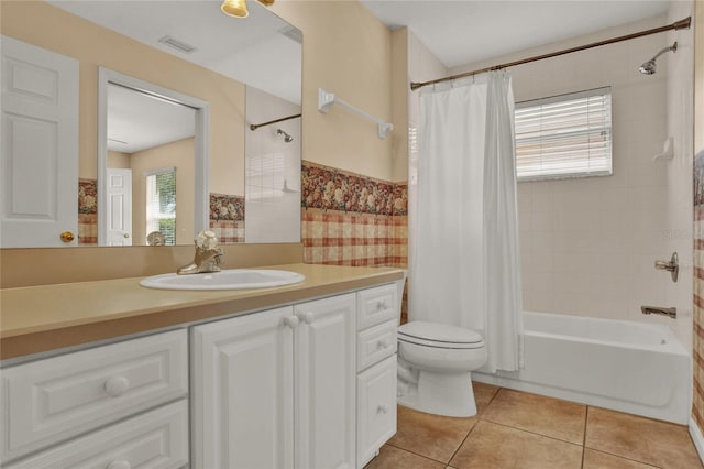 full bathroom featuring visible vents, toilet, shower / tub combo, vanity, and tile patterned floors