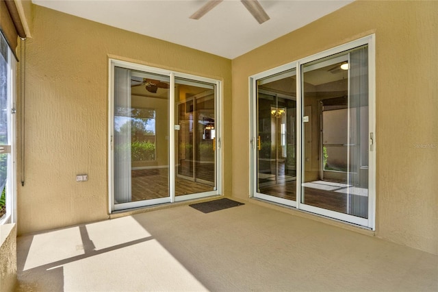 exterior space with a ceiling fan, a patio, and stucco siding