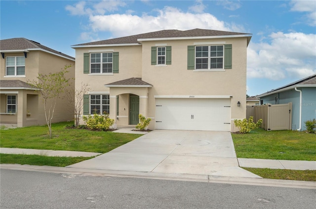 view of front of home featuring driveway, a garage, fence, a front lawn, and stucco siding