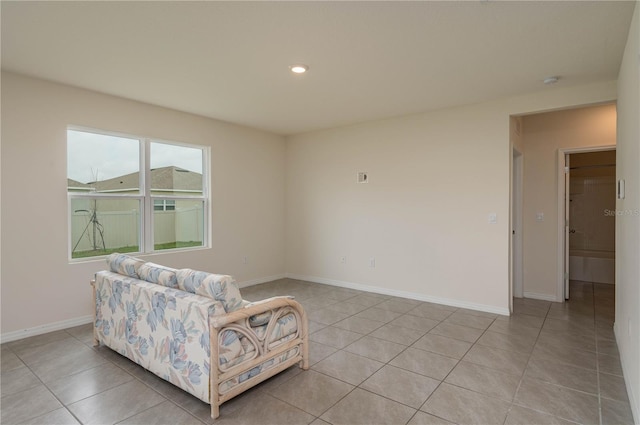 living area featuring light tile patterned floors, recessed lighting, and baseboards