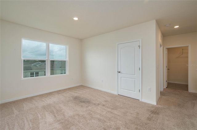 unfurnished room featuring carpet floors, recessed lighting, and baseboards