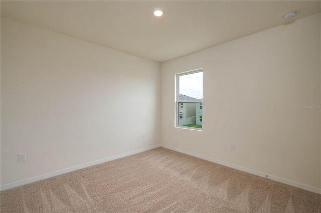 carpeted spare room with recessed lighting and baseboards