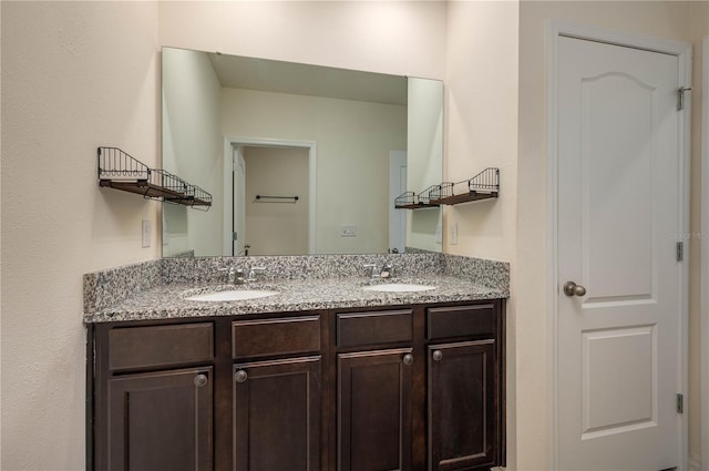 full bathroom featuring a sink and double vanity