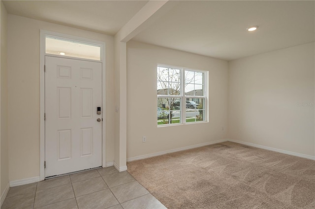 entryway with baseboards, recessed lighting, light tile patterned flooring, and light colored carpet