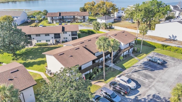 drone / aerial view featuring a residential view and a water view