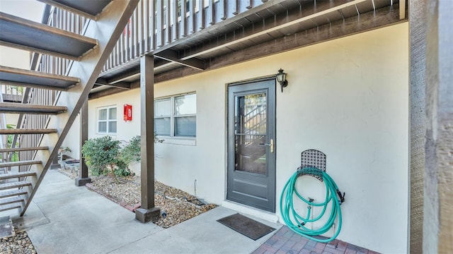 entrance to property with stucco siding