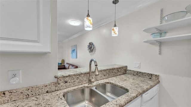 kitchen with white dishwasher, a sink, white cabinetry, decorative light fixtures, and crown molding