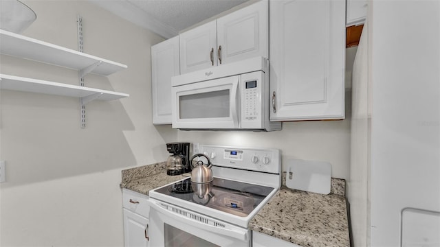 kitchen featuring open shelves, white appliances, white cabinetry, and light stone counters