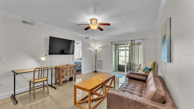 living room featuring ceiling fan, a textured ceiling, visible vents, and crown molding