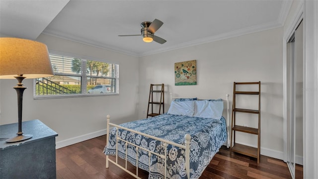 bedroom with baseboards, a closet, ornamental molding, and wood finished floors