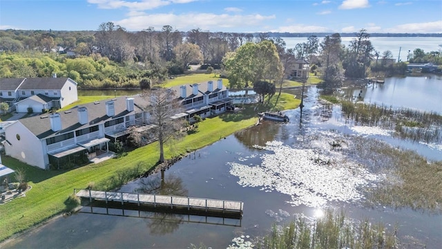 birds eye view of property with a water view and a residential view