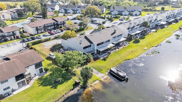 drone / aerial view featuring a water view and a residential view