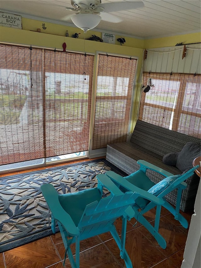 sunroom / solarium featuring ceiling fan