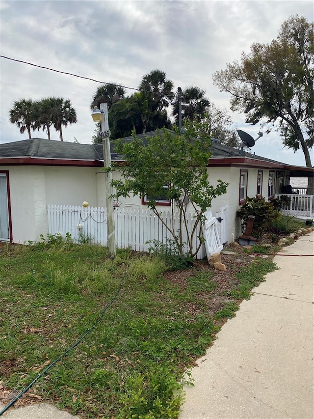 view of side of home featuring fence