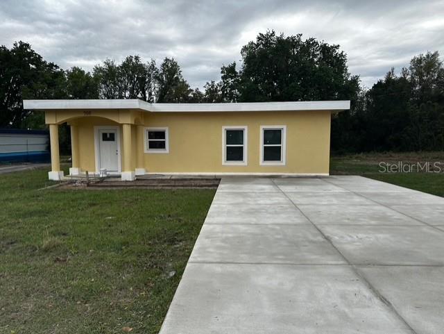 view of front of property with a front yard and stucco siding