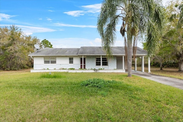 ranch-style house with aphalt driveway, a front lawn, and an attached carport