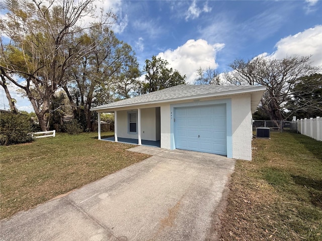 view of front facade featuring stucco siding, a shingled roof, concrete driveway, fence, and a front lawn