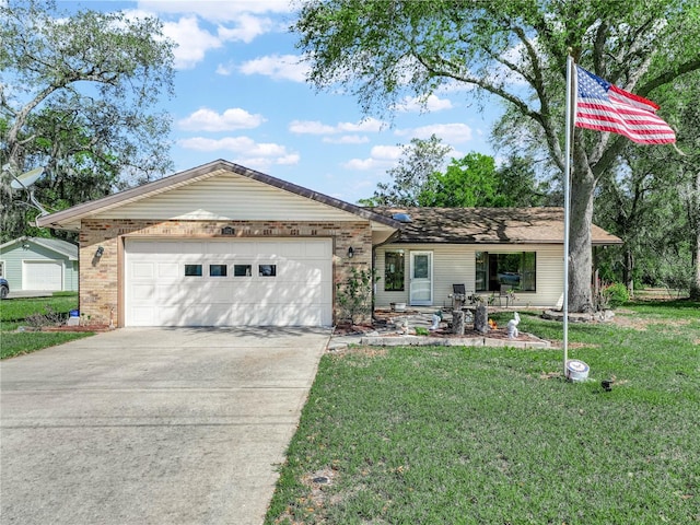 single story home with a garage, a front yard, brick siding, and driveway