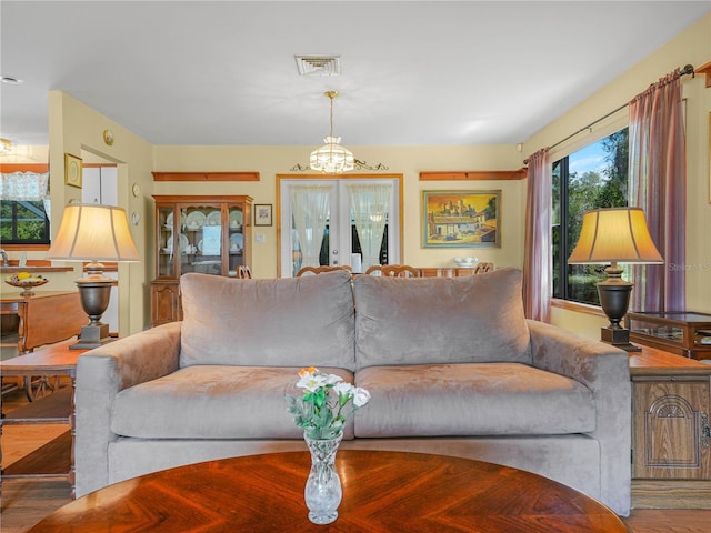 living room featuring french doors, wood finished floors, and visible vents