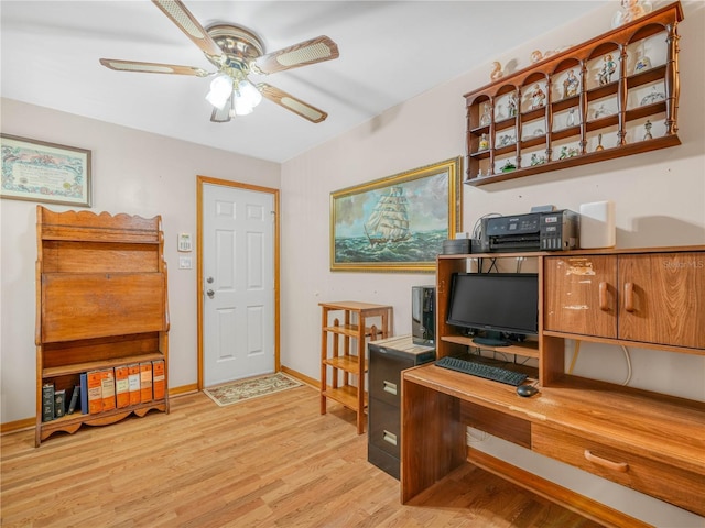 office space featuring baseboards, light wood-style flooring, and a ceiling fan