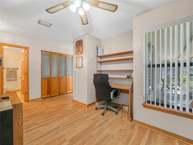 office space featuring baseboards, visible vents, ceiling fan, and light wood finished floors