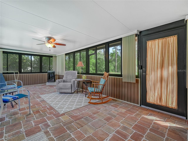 sunroom featuring ceiling fan