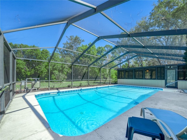 outdoor pool with a lanai and a patio