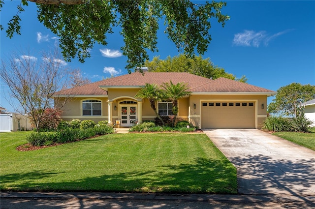 view of front of house with stucco siding, a front lawn, driveway, french doors, and an attached garage