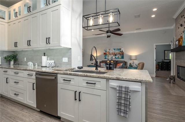 kitchen with ornamental molding, a sink, wine cooler, white cabinets, and dishwasher