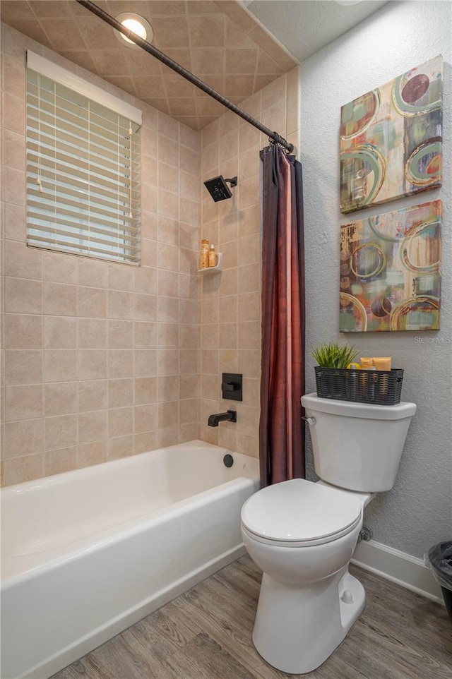 full bathroom with toilet, shower / bath combo, baseboards, and wood finished floors