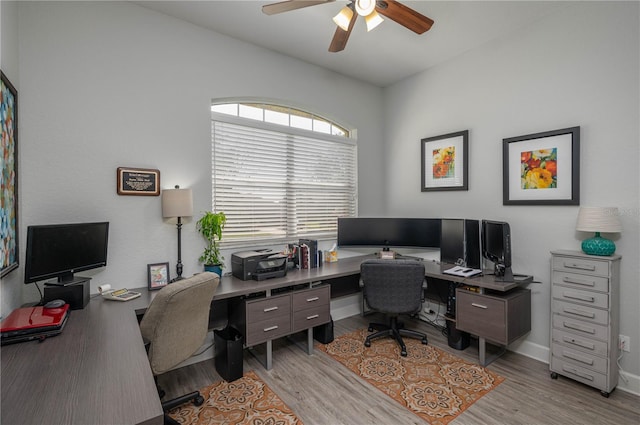 home office with light wood-type flooring, baseboards, and ceiling fan