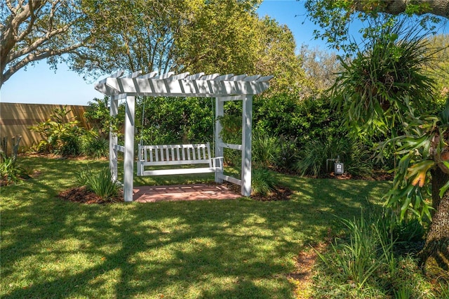 view of yard with a pergola and fence