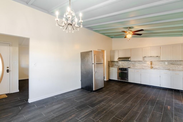 kitchen with wood finish floors, stainless steel appliances, tasteful backsplash, a sink, and under cabinet range hood