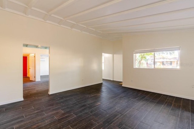 empty room with dark wood-style floors and baseboards