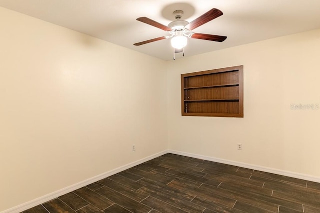 unfurnished room with baseboards, dark wood finished floors, and a ceiling fan