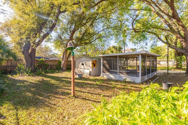 view of yard with a sunroom and fence